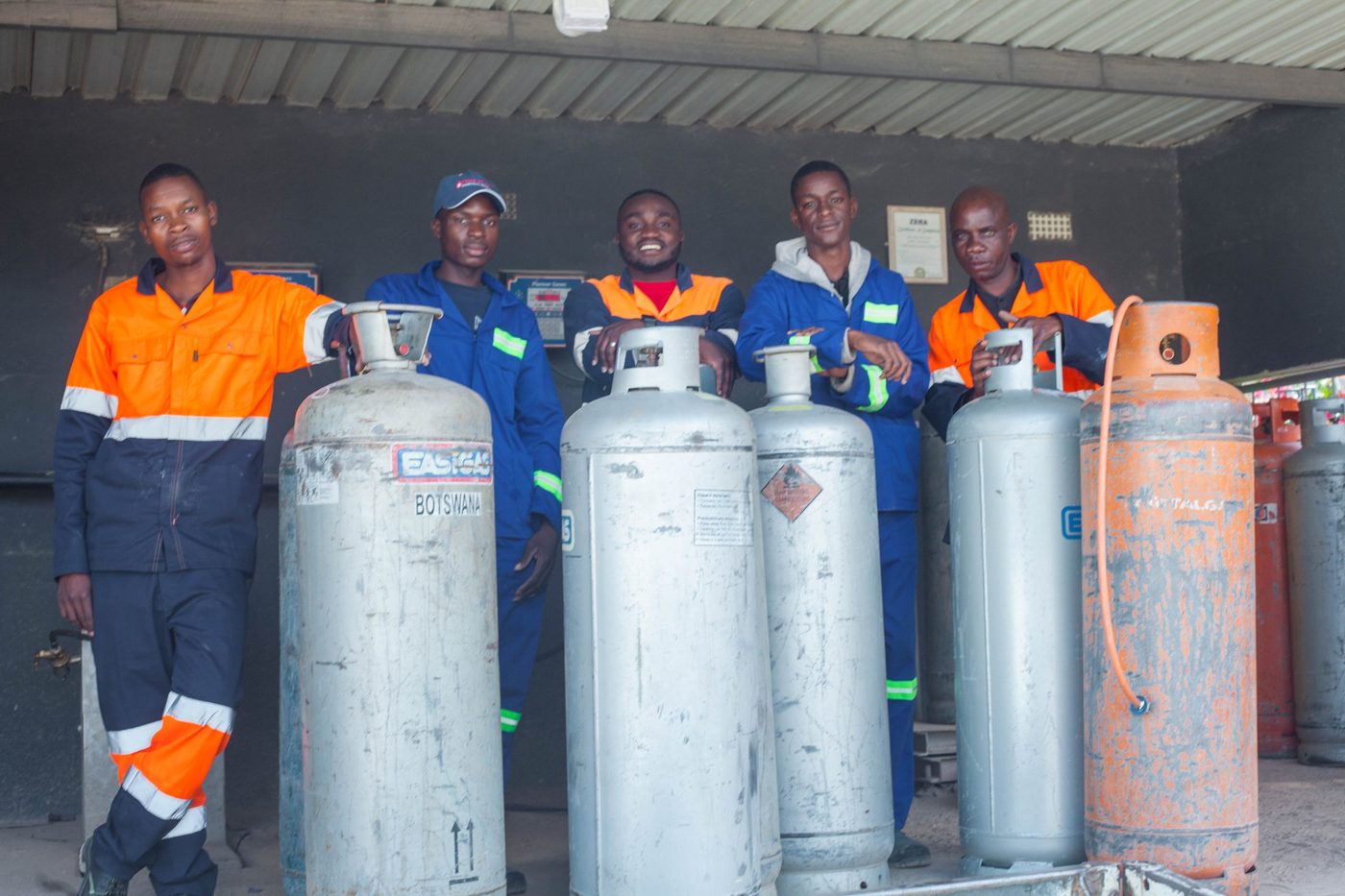 Pandi technicians with LPG cylinders at a filling depot